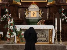 صورة تمثّل راهبة ترفع الصلاة في الكنيسة